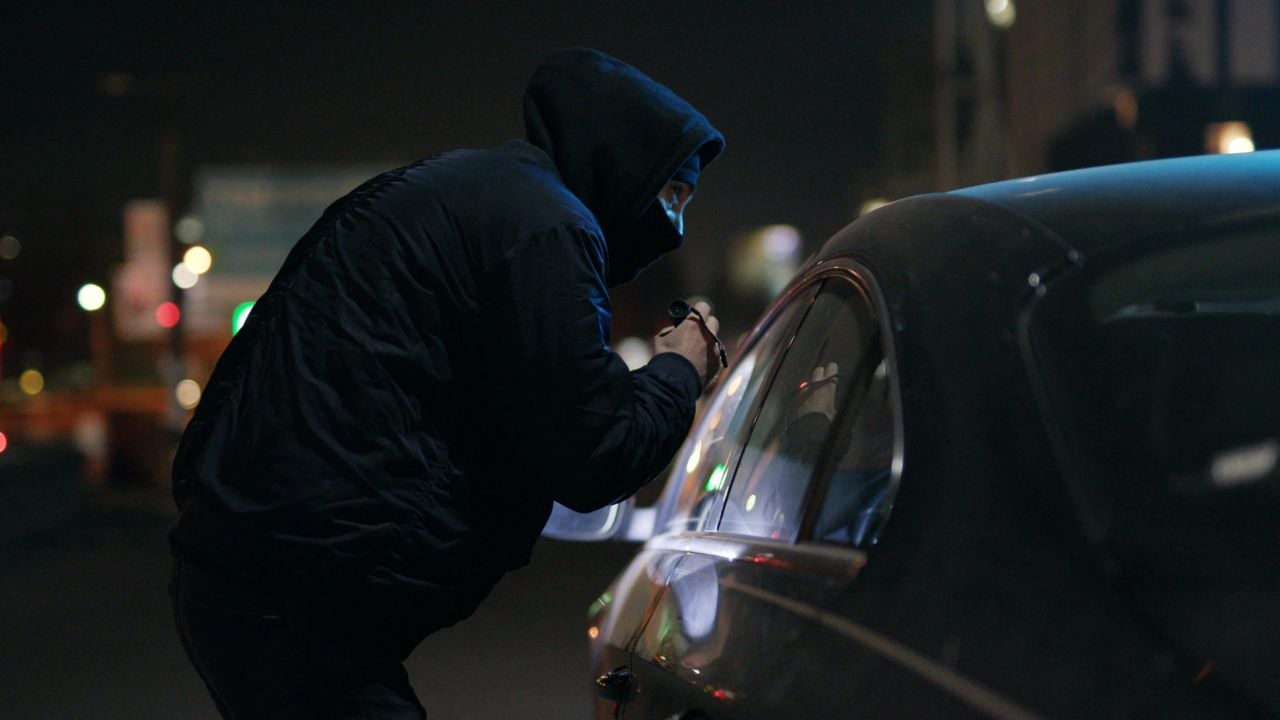 thief looking at car