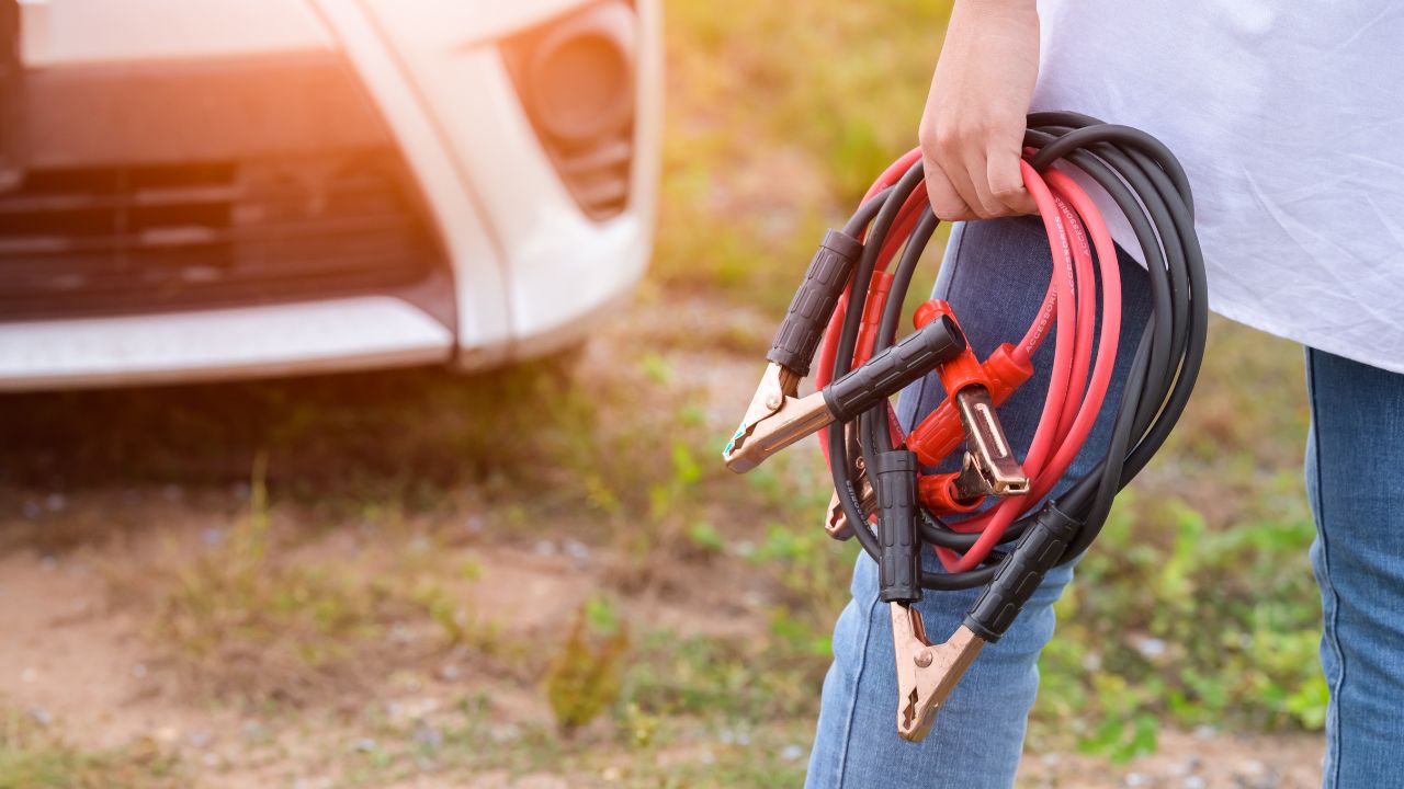 woman holding jump cables