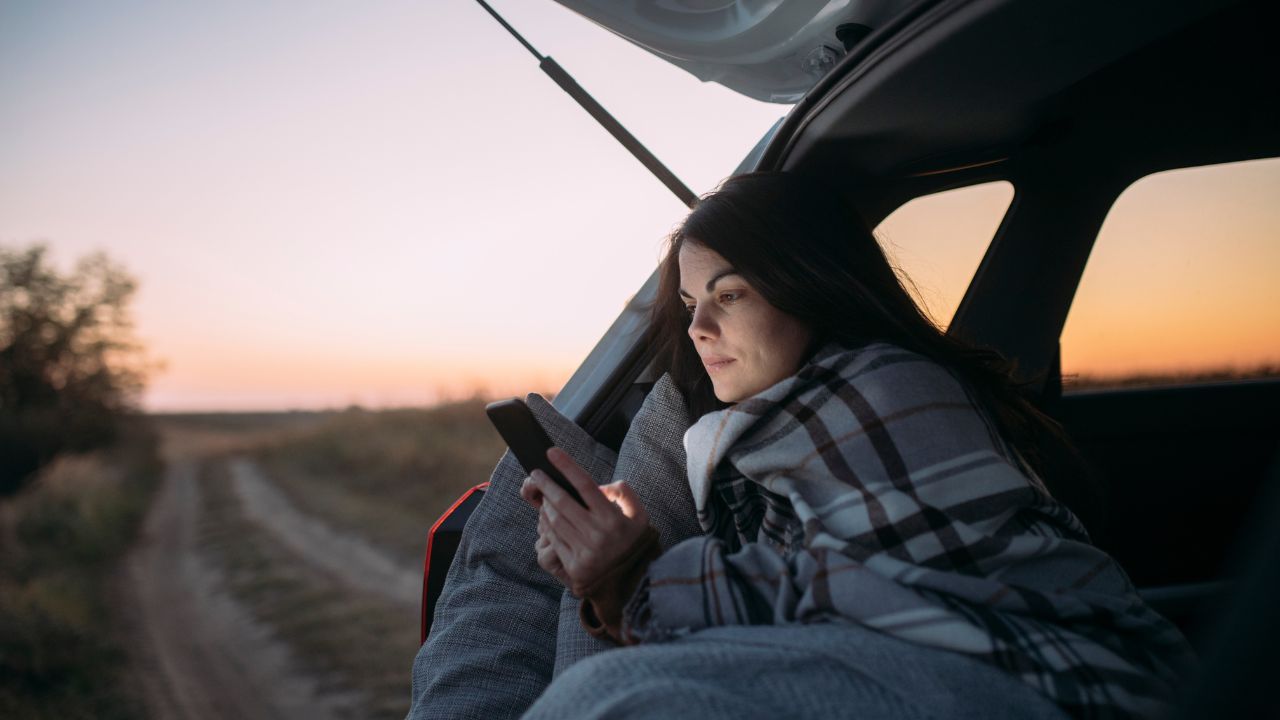woman in blanket in car