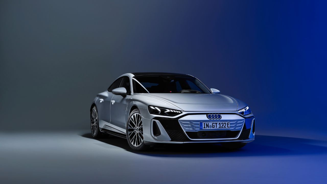 A silver 2022 Audi E-Tron GT under blue lights.