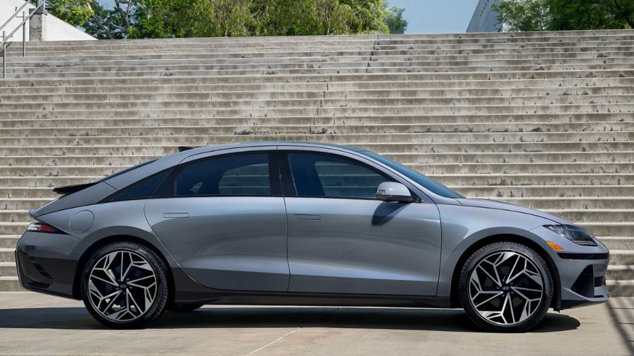 A metallic gray 2025 Hyundai Ioniq 6 outdoors in front of steps on a sunny day.