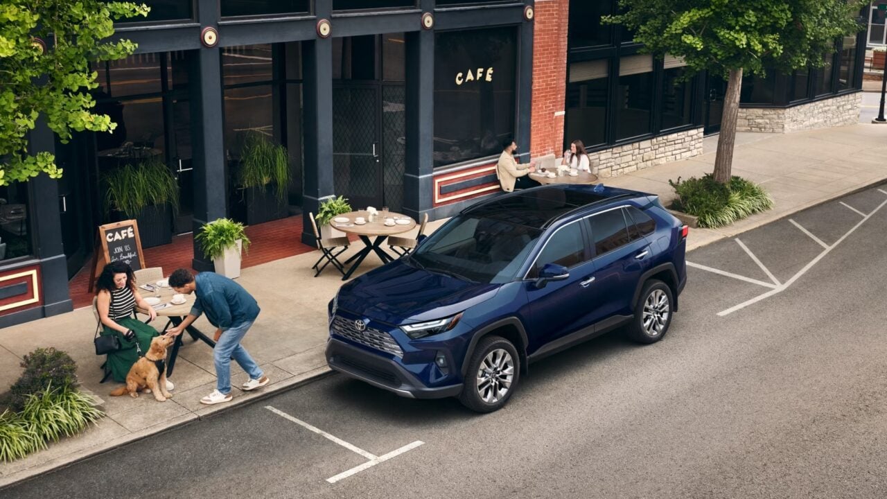 2025 Toyota RAV4 on city street with people