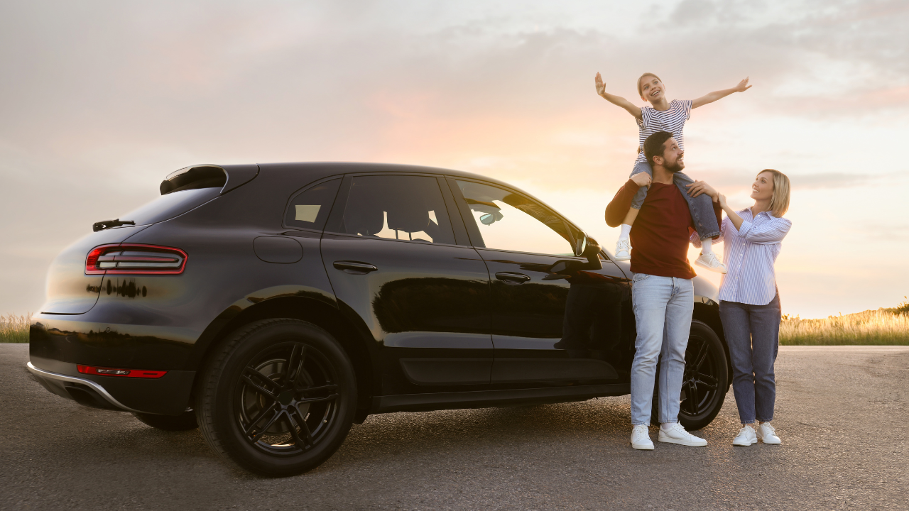 Happy family enjoying road trip. Parents and daughter near car
