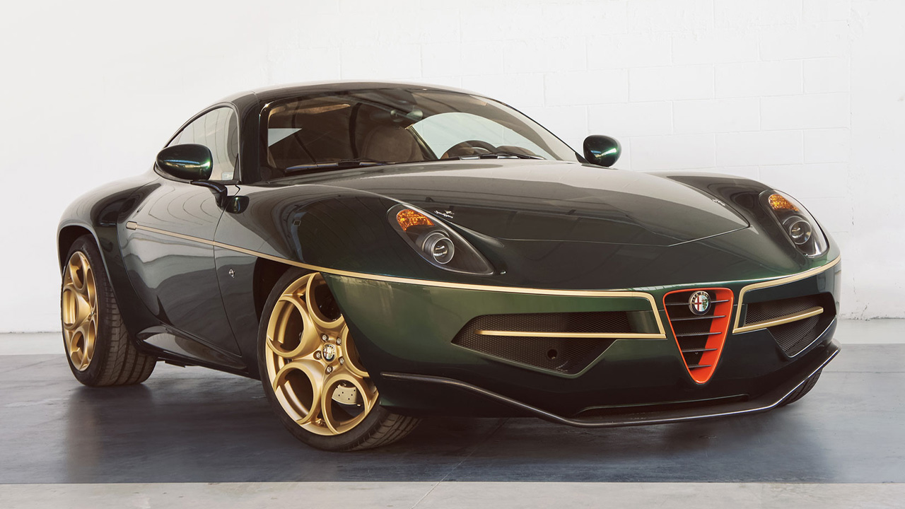 A customer Alfa Romeo Disco Volante, green exterior with gold and red accents, front 3/4 view