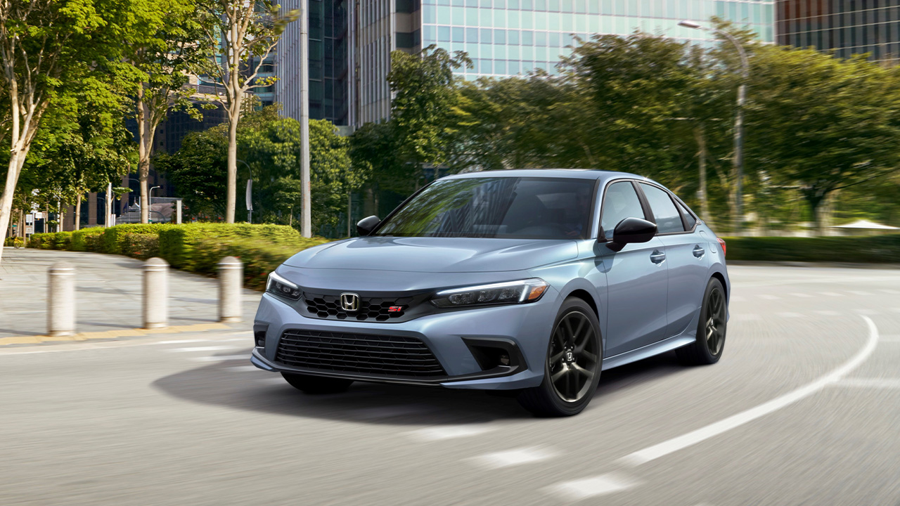 An eleventh generation Honda Civic Si in gray, front 3/4 view