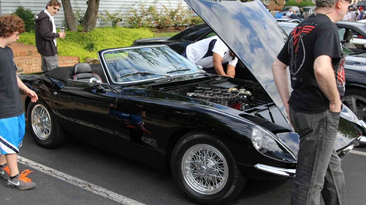 Black Intermeccanica Italia Spyder with open hood.
