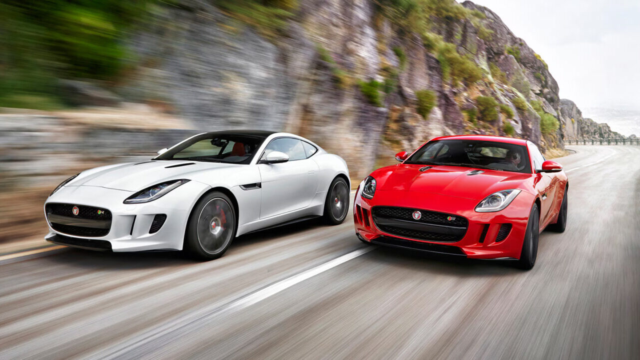 2 Jaguar F-Types driving.