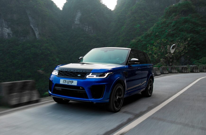 A blue Range Rover Sport SVR on a mountain road, front 3/4 view