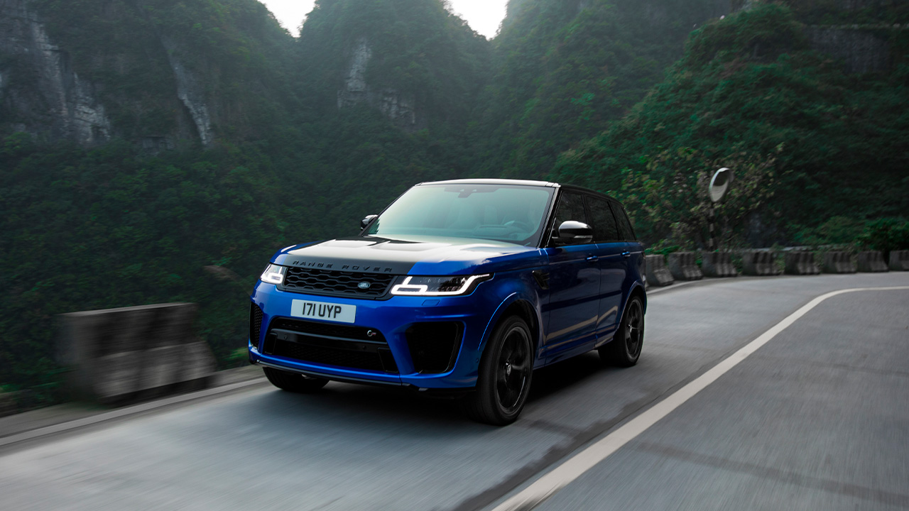 A blue Range Rover Sport SVR on a mountain road, front 3/4 view