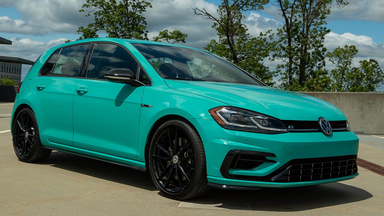 A Mk7 Volkswagen Golf R in the special Sarantos Turquoise paint color, front 3/4 view