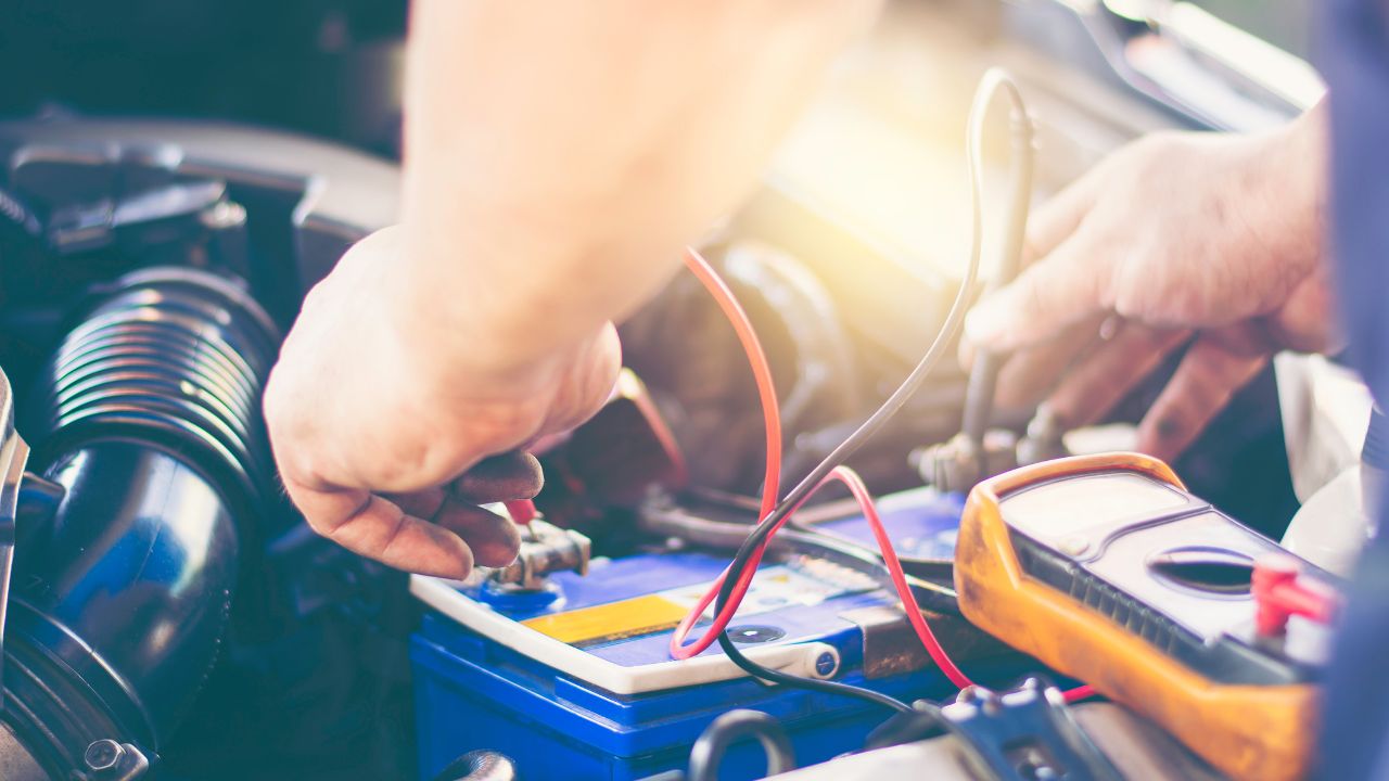 man working on car battery