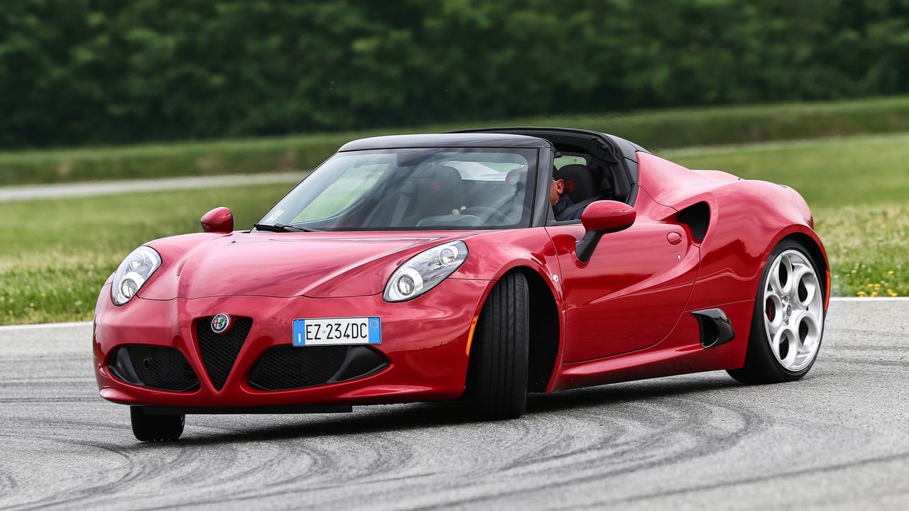 Red 2016 Alfa Romeo 4C Spider Drifting With Roof Down Front 3/4 View