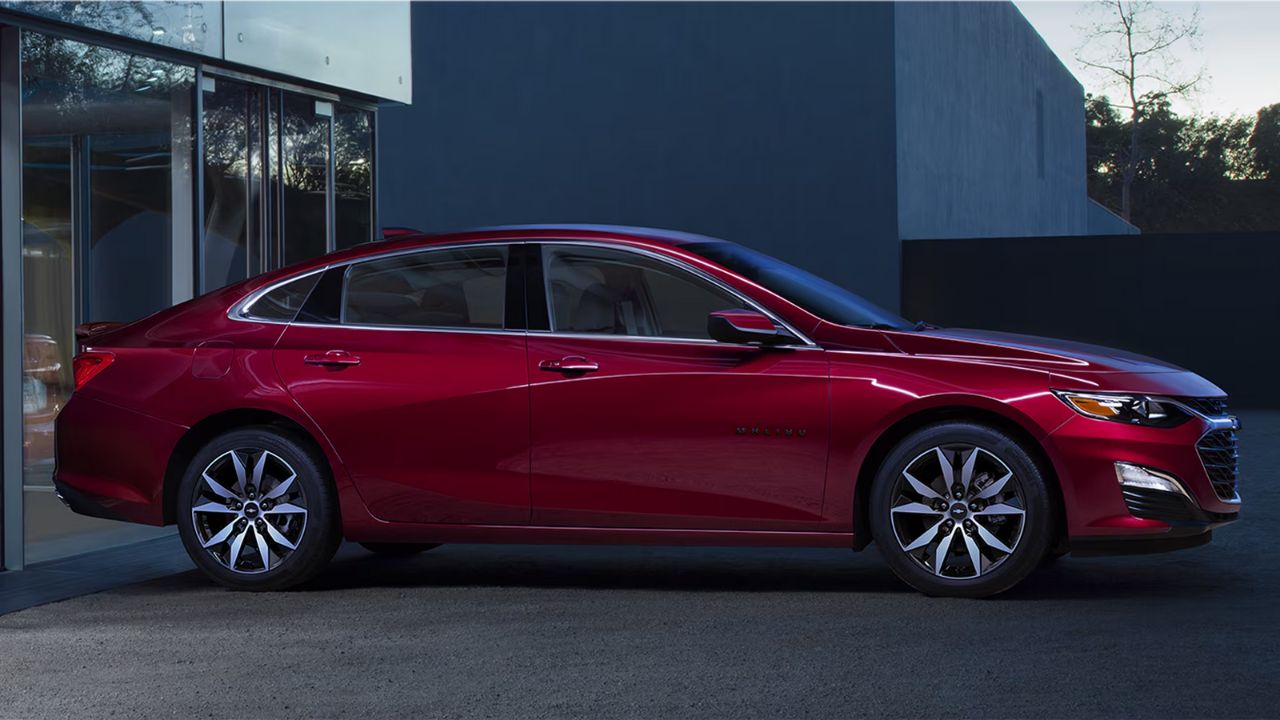 A red 2024 Chevrolet Malibu in the city.