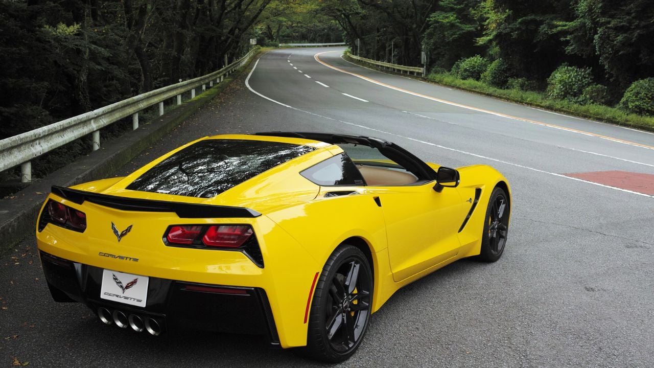 Yellow Chevrolet C7 Corvette Z51 Parked With Roof Down Rear 3/4 View Front 3/4 View