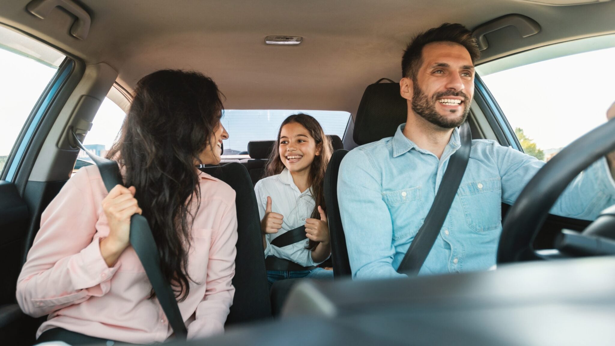 Happy family on a road trip in a car driving