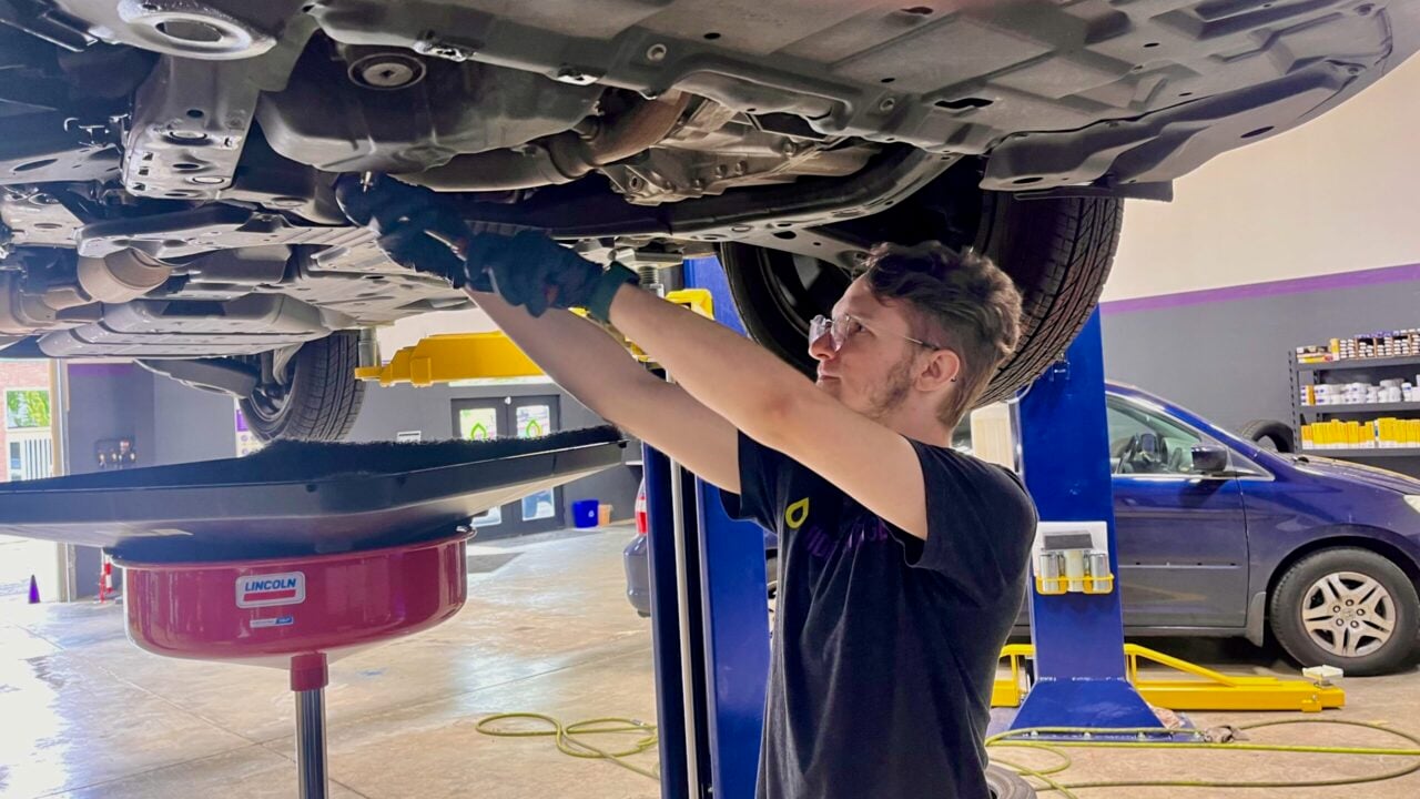 Mechanic doing oil change.