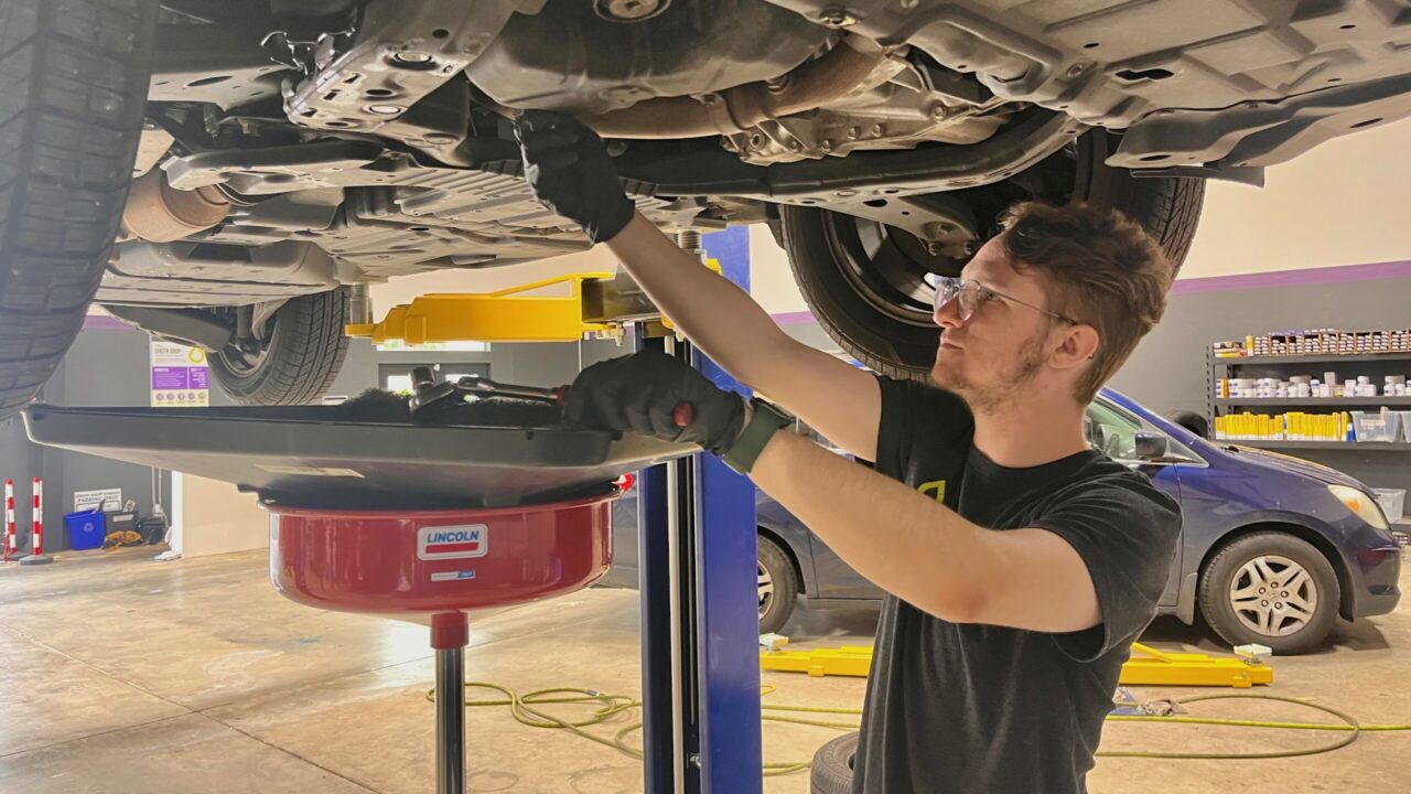Mechanic doing oil change.