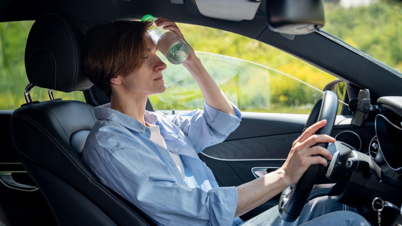 A woman in her vehicle during a heatwave