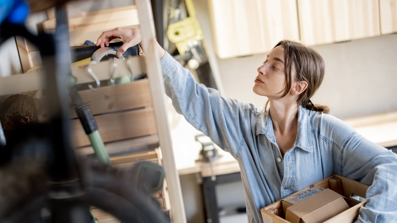 A woman looking through boxes in her garage