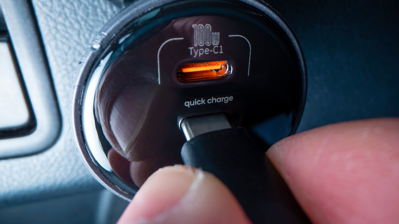 Close-up view of plugging in USB type C cable into a powerful car charger, shot with macro probe lens