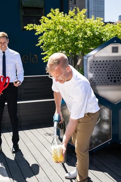 Eric Dahlgren, co-founder of Aircela, fills a bottle with gasoline made on-site—produced in real time by the Aircela machine