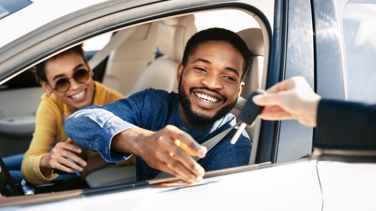 Happy young man buying his first car