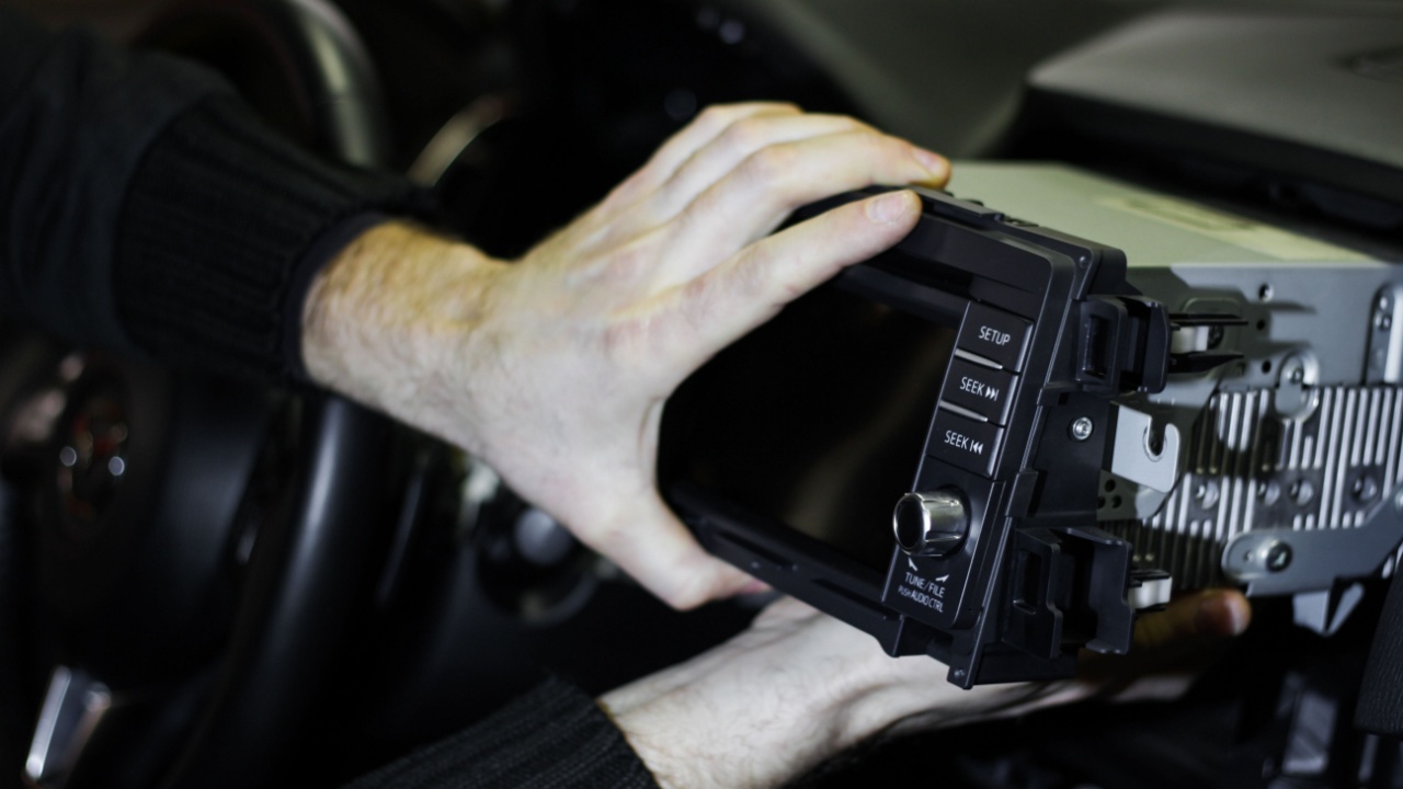 Man installing a new car stereo