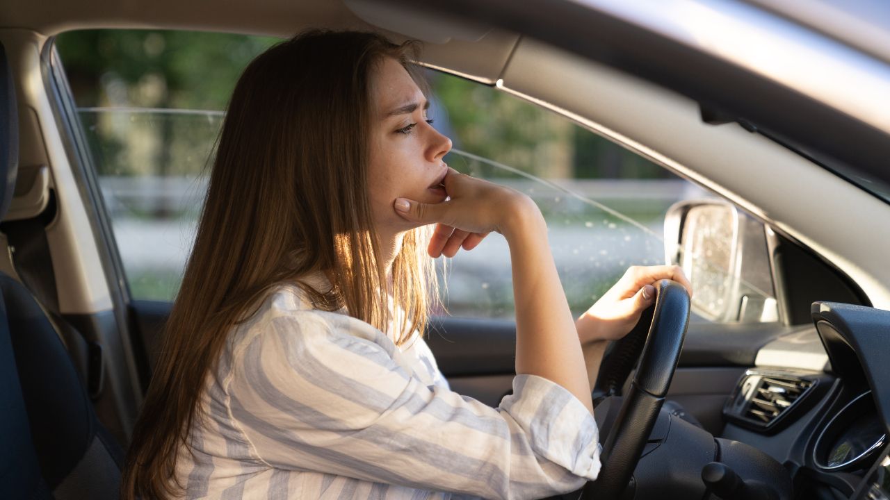 Person, woman, worried in a car