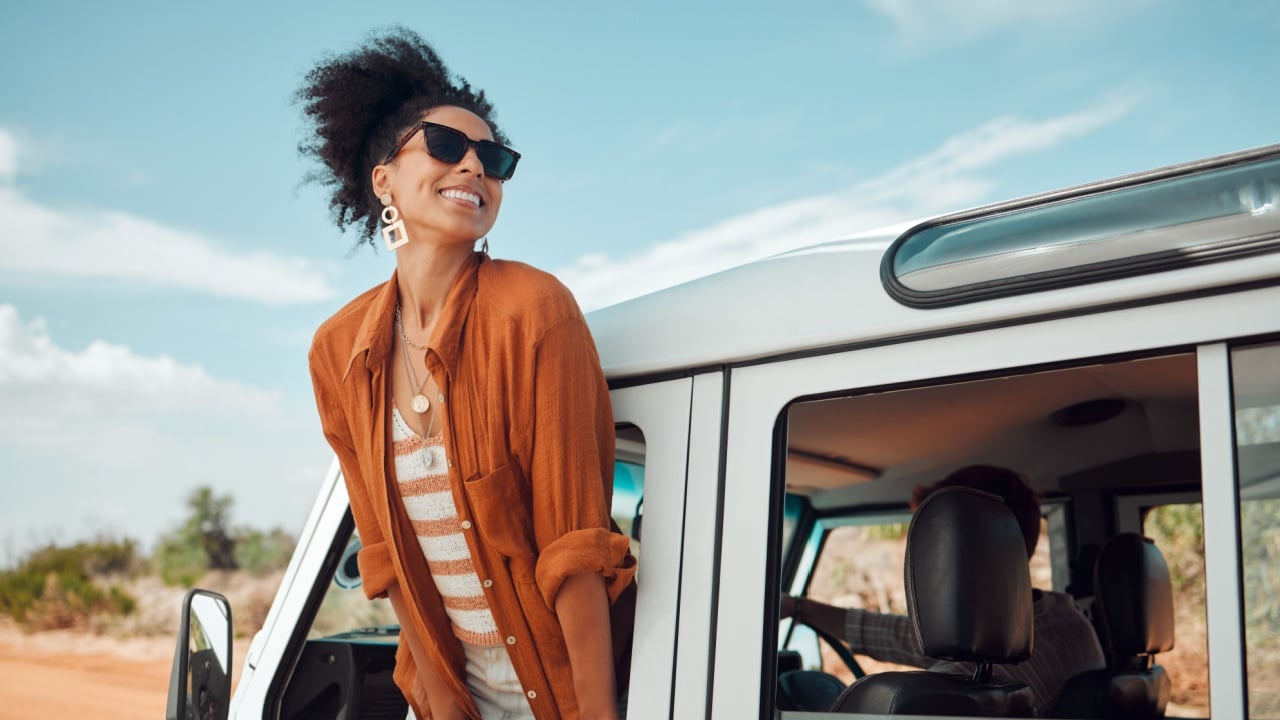 Woman on a road trip, happy to be on an adventure