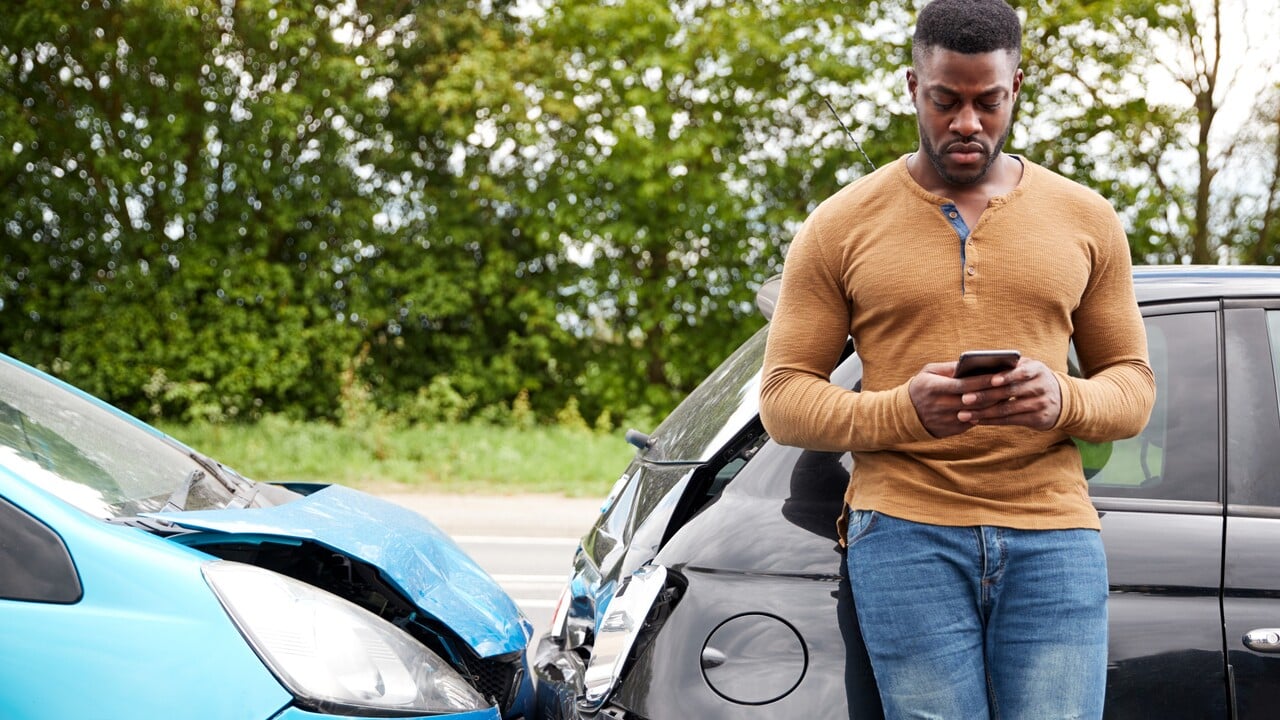 Male Motorist Involved In Car Accident Calling Insurance Company Or Recovery Service