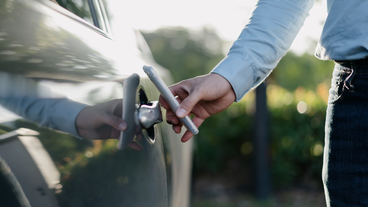 businessman unlock car with smartphone