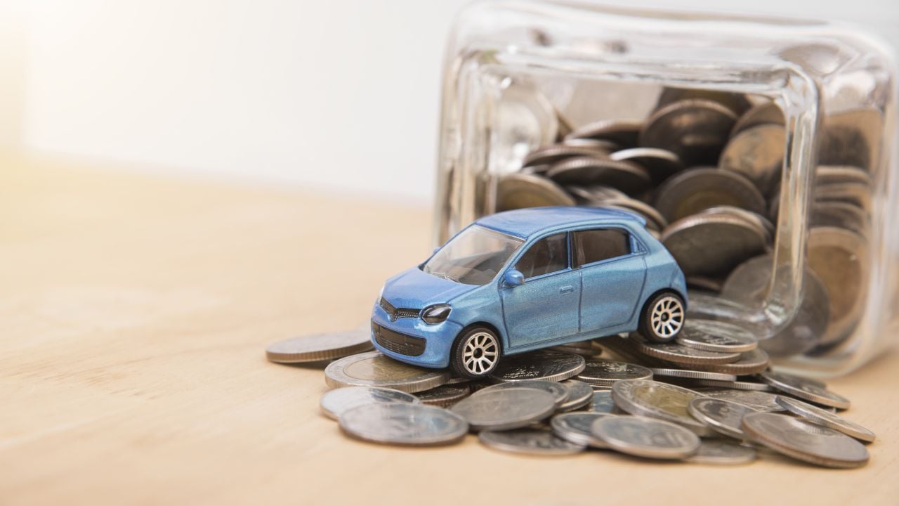 car with money coin on wood table. insurance concept