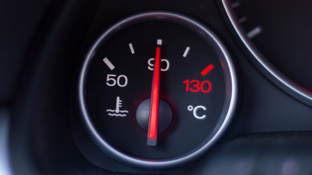 Car temperature gauge, dial, showing 90 degrees Celsius. Warming up the car. Car thermostat working.