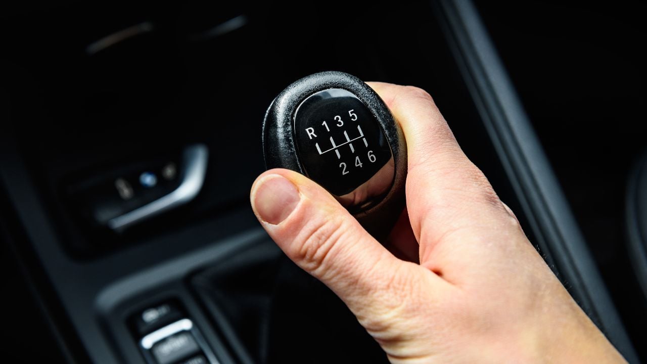 Driver shifting the gear on car manual gearbox.