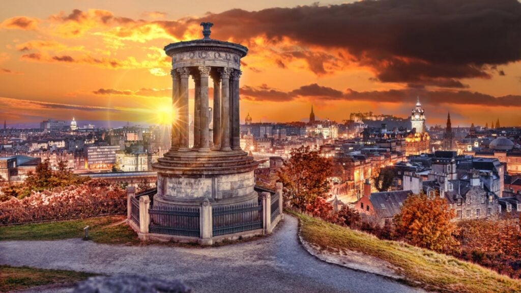Edinburgh with Calton Hill against autumn leaves in Scotland