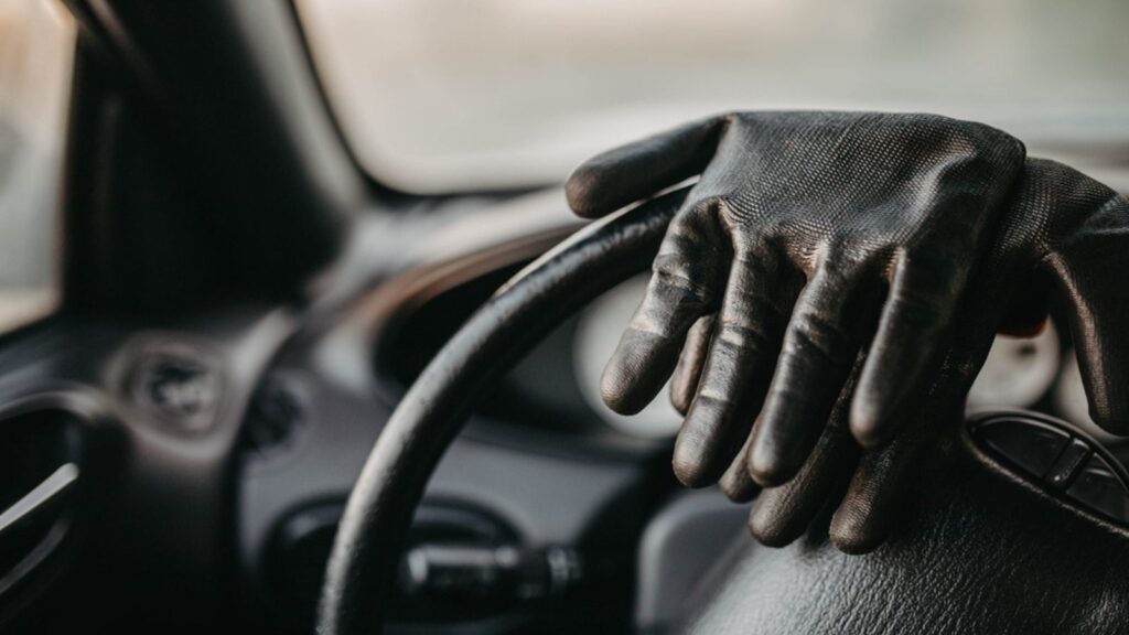 Driver's gloves on the steering wheel