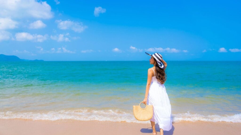 Portrait beautiful young asian woman happy smile leisure on the beach sea and ocean with blue sky white cloud for vacation travel