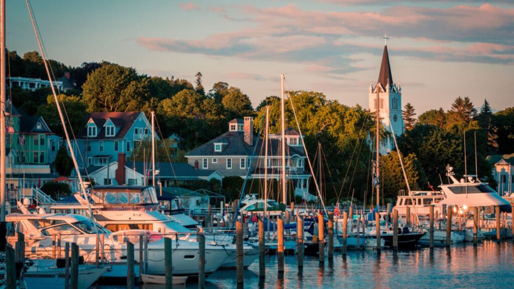 The Marina at Mackinac Island with Saint Anne's church and the historic victorian houses a sunset shot from Lake Michigan