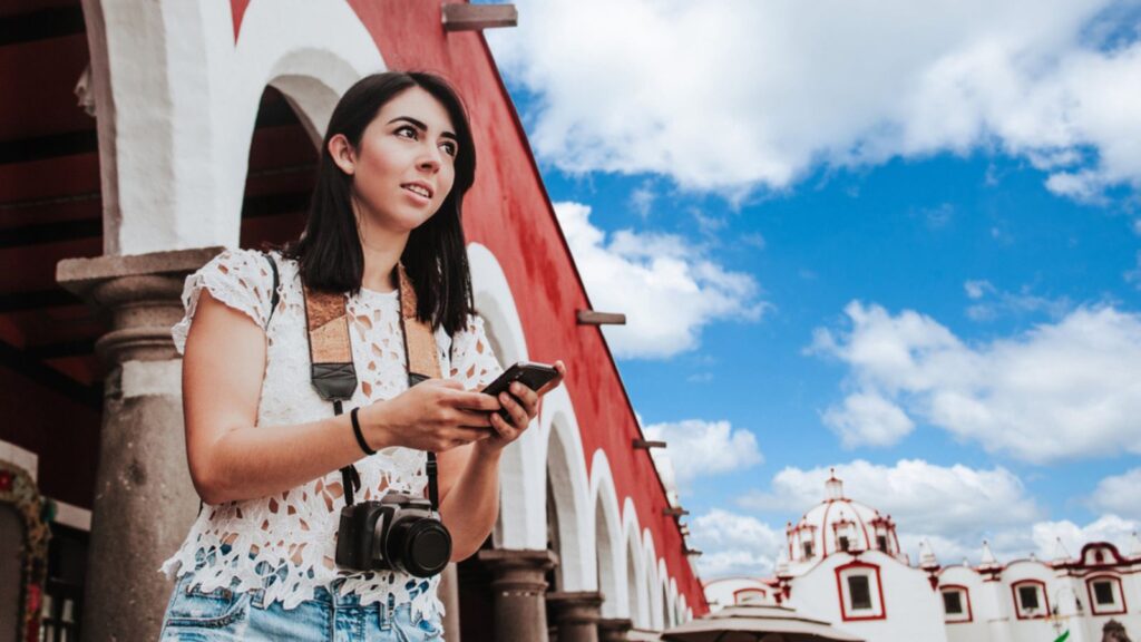 Traveling Latin Woman tourist backpackers taking photo in Mexico city