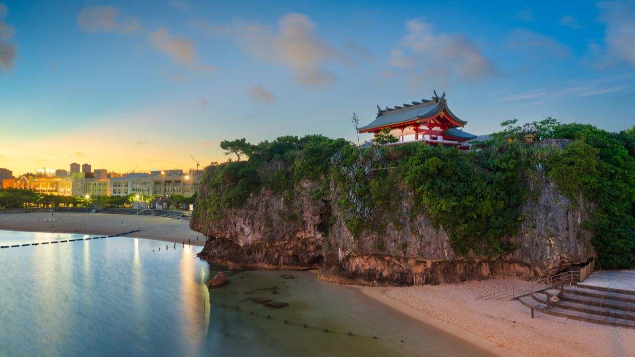 Naha, Okinawa, Japan townscape from Naminoue Beach at golden hour.