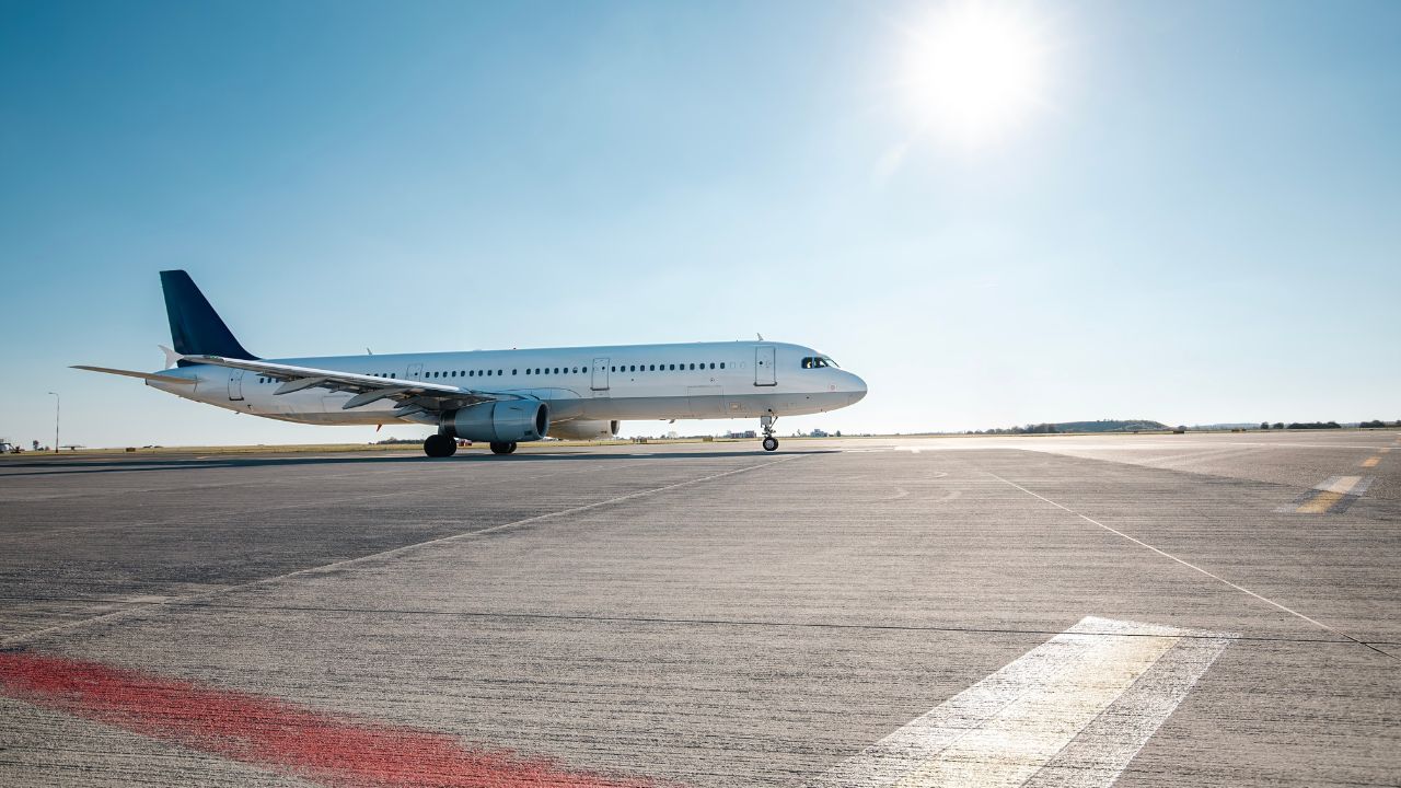 Commercial airplane during taxiing on taxiway to airport runway for take off on sunny day.