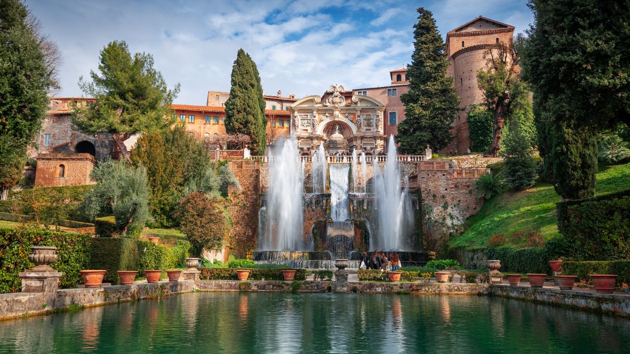 TIVOLI, ITALY - FEBRUARY 5, 2022: Visitors enjoy waterworks at Villa D'Este. The 16th century villa is now a museum and an UNESCO World Heritage site.