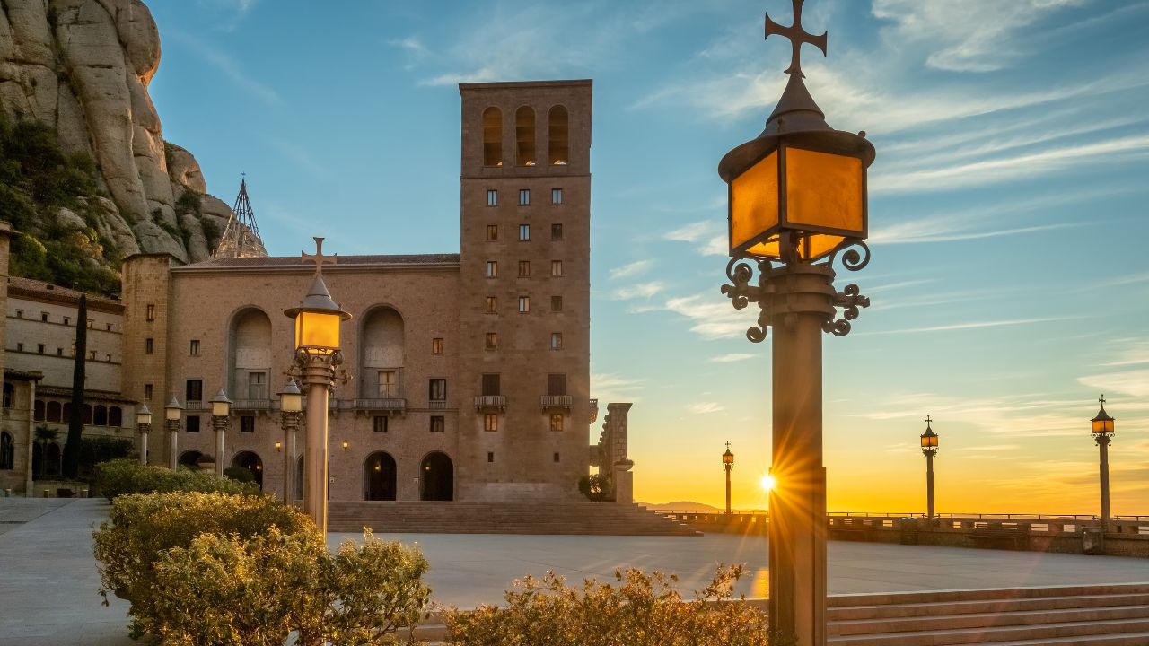 Inner yard of the Montserrat monastery, abbey of the Order of Saint Benedict Monastery of Montserrat at sunrise in Catalonia, Spain. Main square in Montserrat monastery