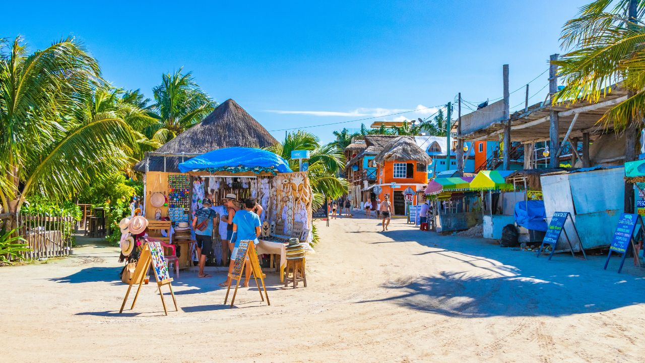 Holbox Mexico 21. December 2021 Panorama landscape view on beautiful Holbox island sandbank and beach with entrance people stores bars and palm trees in Quintana Roo Mexico.