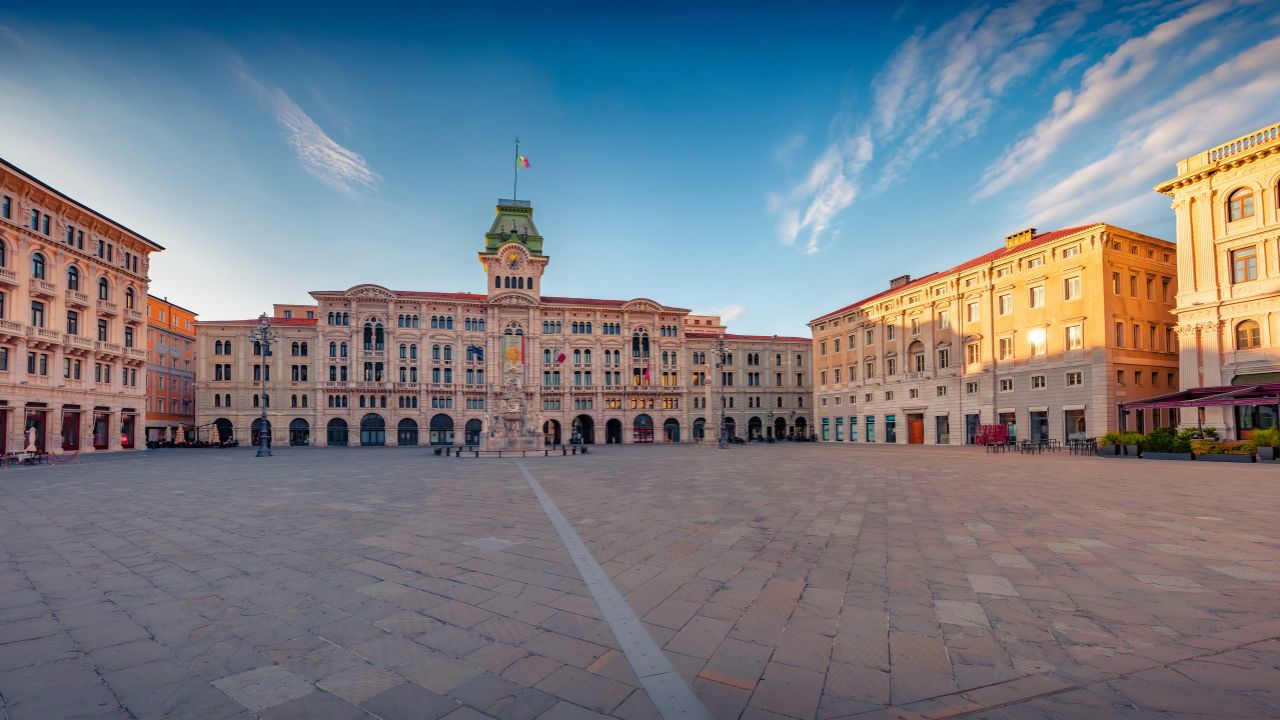 Panoramic summer cityscape Trieste, Italy, Europe. Stunning morning view of popular tourist attraction - Unity of Italy Square. Traveling concept background.