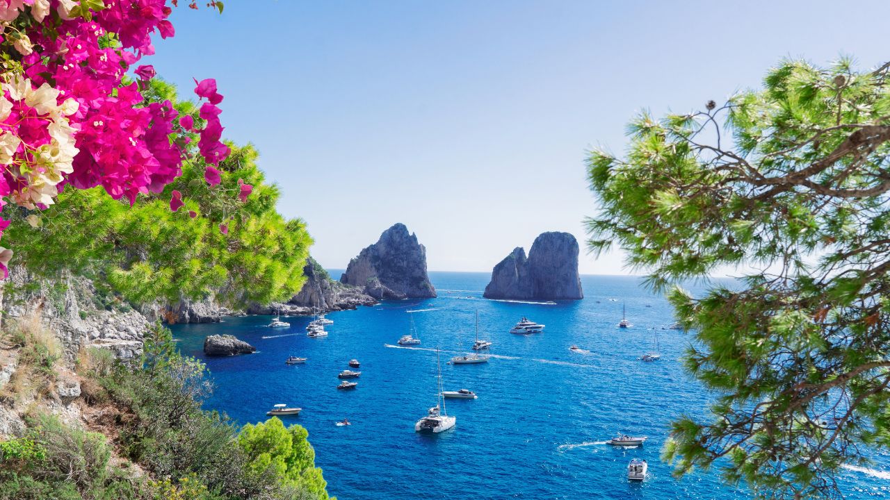 Famous Faraglioni cliffs and Capri island coast, Italy, retro toned