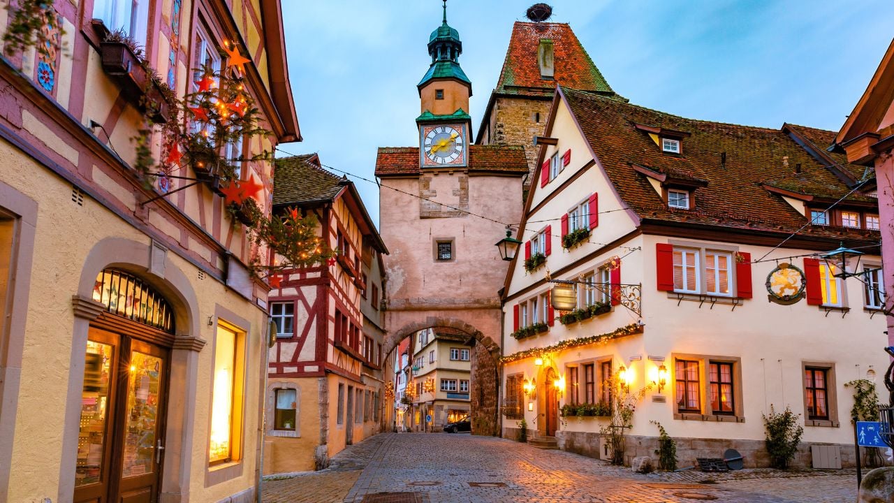 Decorated and illuminated Christmas street with gate and tower Markusturm in medieval Old Town of Rothenburg ob der Tauber, Bavaria, southern Germany