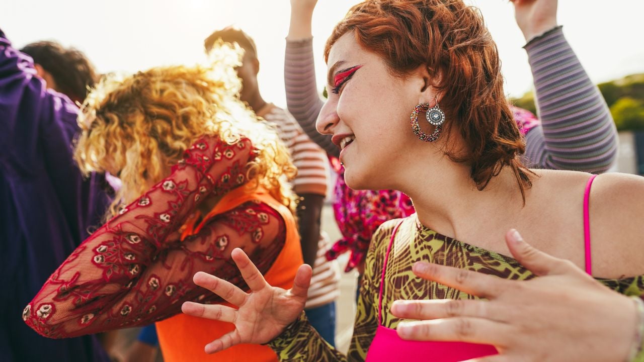 Happy young people dancing outdoor at festival event - Party, summer and entertainment concept - Focus on red girl face