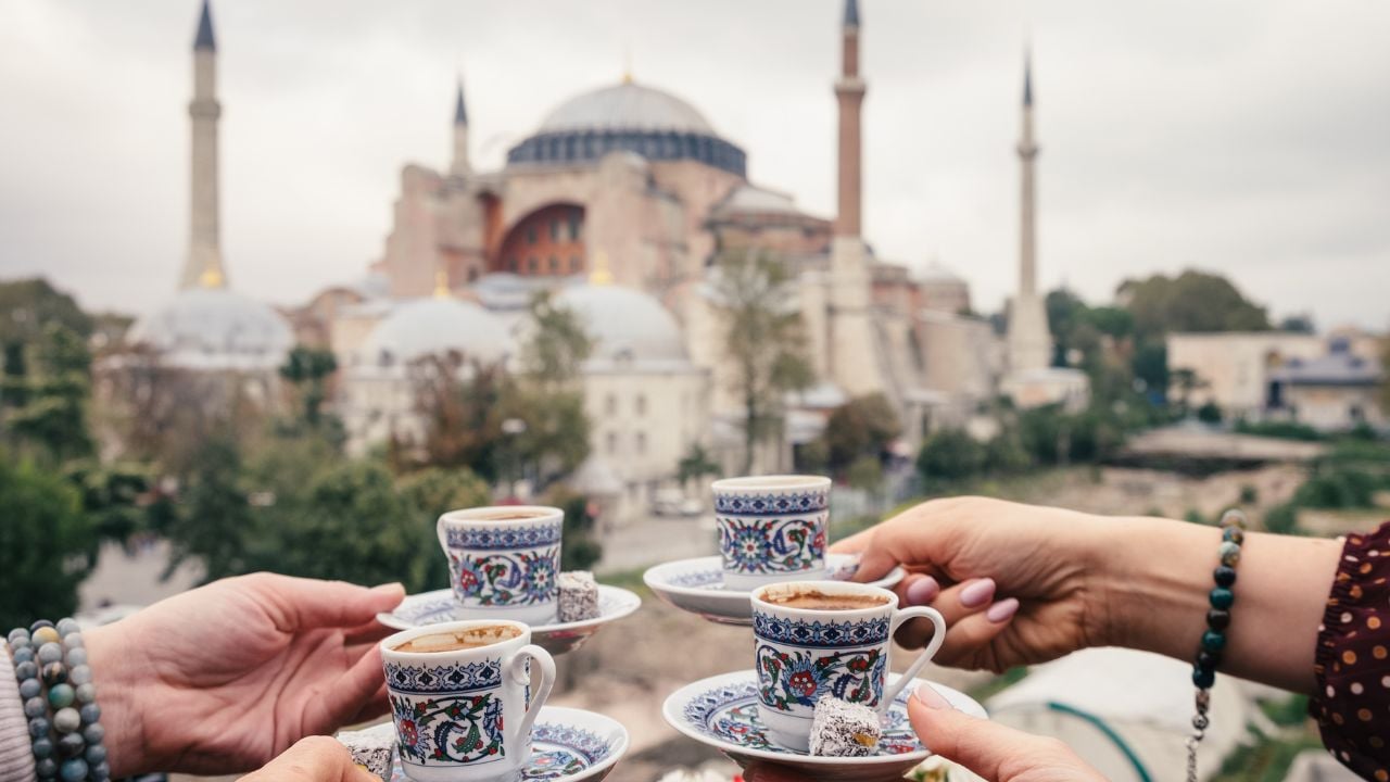 Woman travel in Istanbul and and drink turkey coffee in cafe near Hagia Sophia famous islamic Landmark mosque, Travel to Istanbul, Turkey background