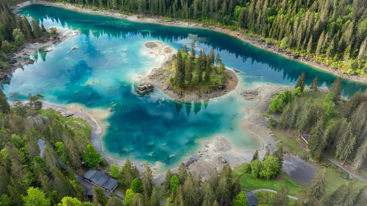 Stunning view of the lake Cauma near Flims in Canton Graubunden in Switzerland. Caumasee lake with a small island located in the middle of the crystal clean lake.